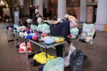 Auf einem Tapeziertisch und in mehreren Säcken liegt gesammelte Wolle in der Citykirche in Aachen.